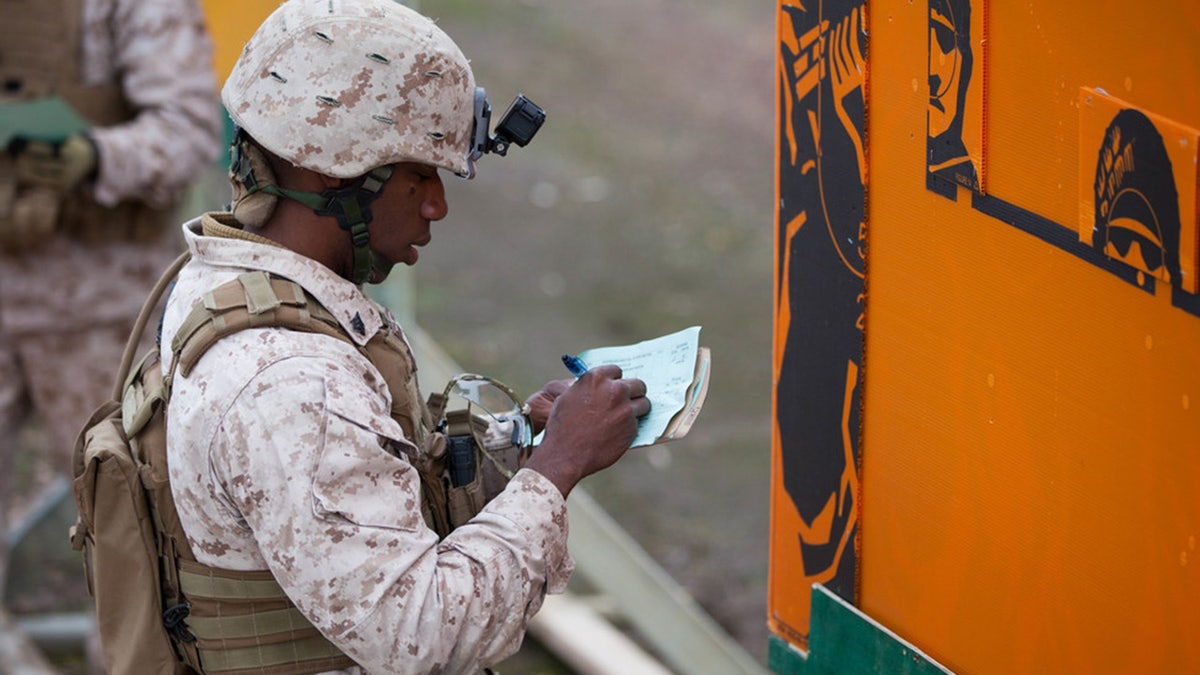 Sgt. Jacques Yves Duroseau grades a competitor’s score after the barricade match at Puckapunyal Military Area, Victoria, Australia, May 11, 2016.