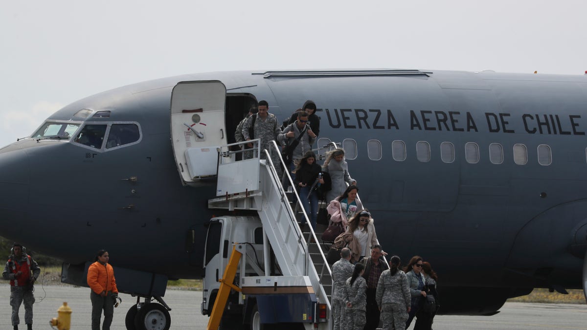 Relatives of passengers of a missing military plane arrive in a Chilean military airplane to an airbase in Punta Arenas, Chile, Wednesday, Dec. 11, 2019. (AP Photo/Fernando Llano)
