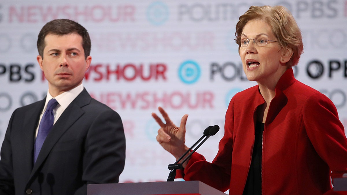 Sen. Elizabeth Warren (D-MA) speaks as former South Bend, Ind., Mayor Pete Buttigieg listens during the Democratic presidential primary debate at Loyola Marymount University on Dec. 19, 2019 in Los Angeles, Calif.