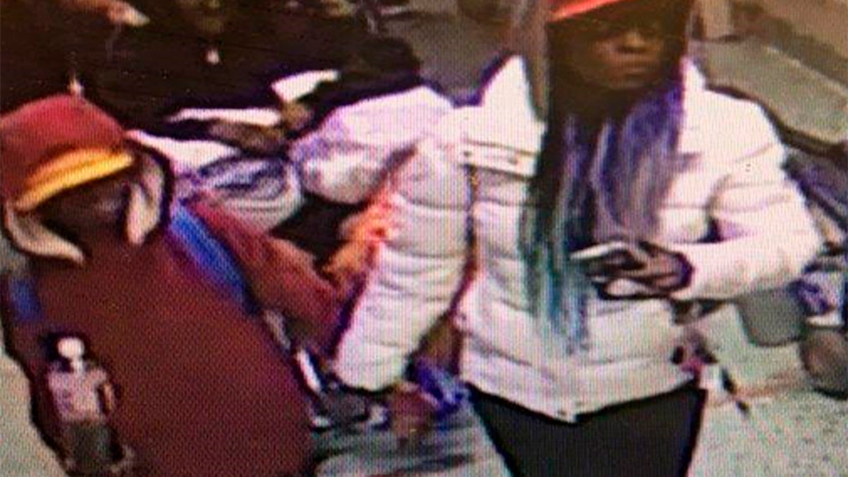 In this image taken from surveillance video released by the Atlanta Police Department, a woman escorts a young man into Grady Memorial Hospital in Atlanta on the night of Dec. 4. Police later identified the woman as Diana Elliott, and arrested her.