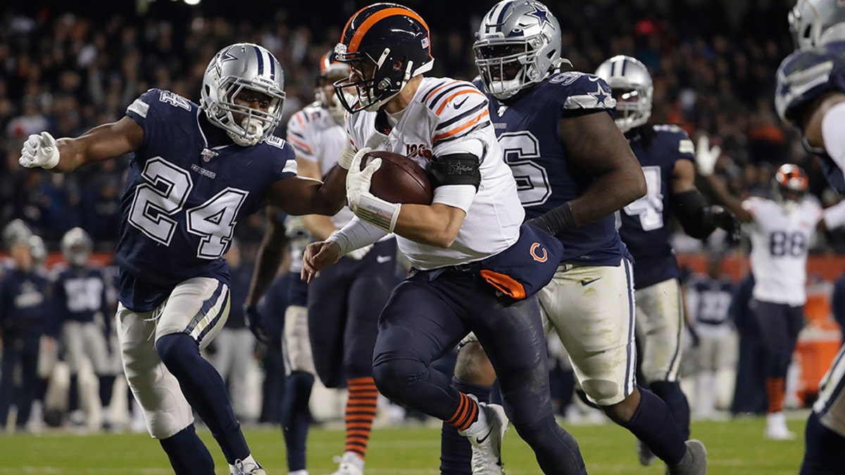 Chicago Bears quarterback Mitchell Trubisky (10) runs in for a touchdown against Dallas Cowboys' Chidobe Awuzie (24) during the second half of an NFL football game, Thursday, Dec. 5, 2019, in Chicago. (Associated Press)