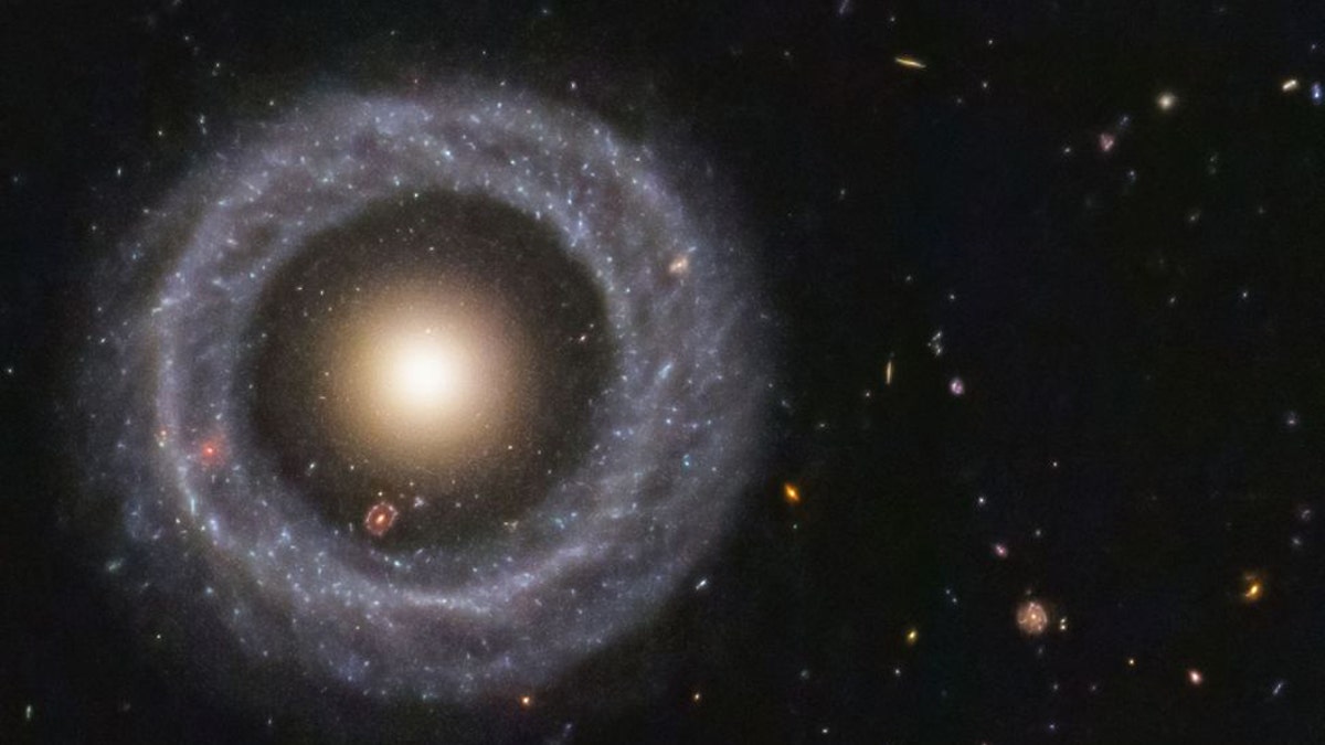 With a perfectly symmetrical ring circling a red sphere of stars, Hoag's object is one of the prettiest mysteries in the universe. (Credit: NASA/ESA/Hubble)