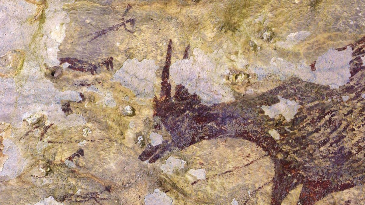 This part of a newly described ancient hunting scene includes a miniature buffalo, or anoa (right), facing five faint human-animal figures wielding spears or ropes, a study finds.