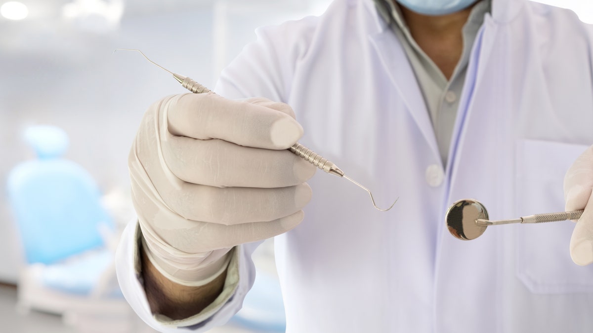 Dentist holds up tool