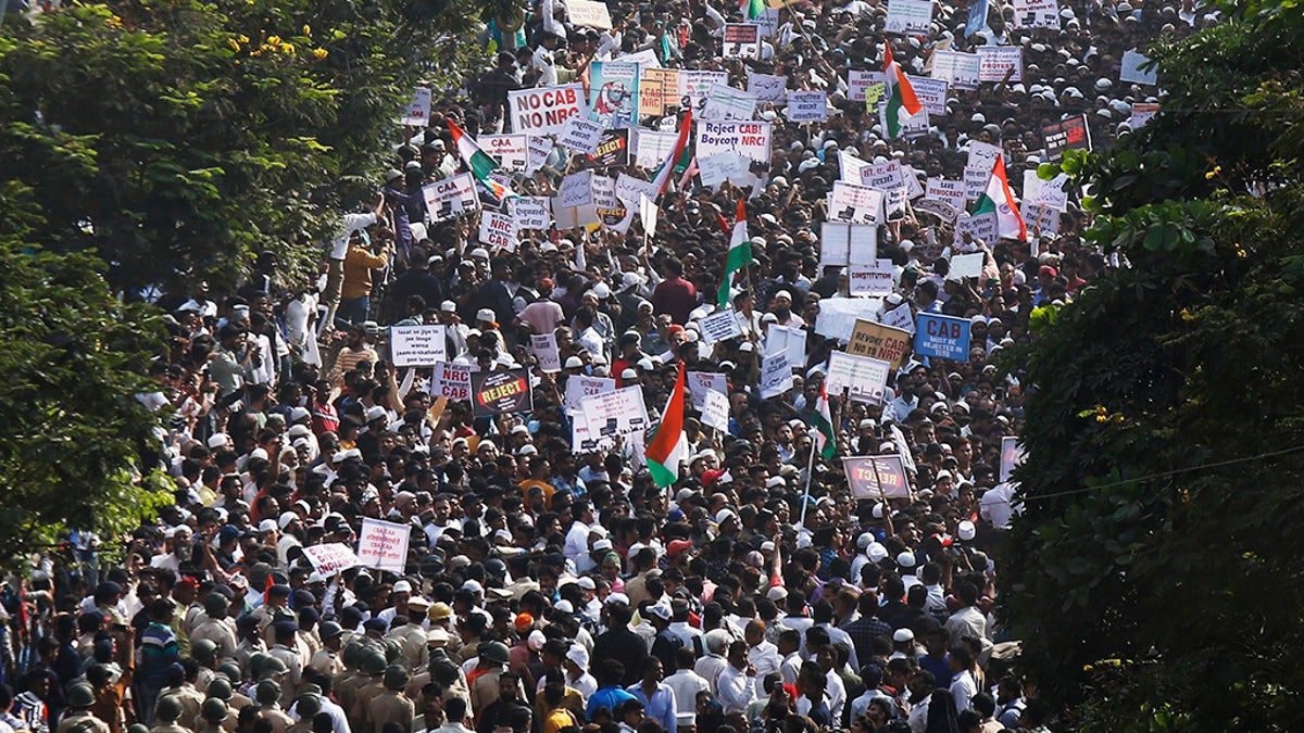 Indians march during a protest against the Citizenship Act in Mumbai, India, Wednesday, Dec. 18, 2019. India's Supreme Court on Wednesday postponed hearing pleas challenging the constitutionality of the new citizenship law that has sparked opposition and massive protests across the country. (AP Photo/Rajanish Kakade)