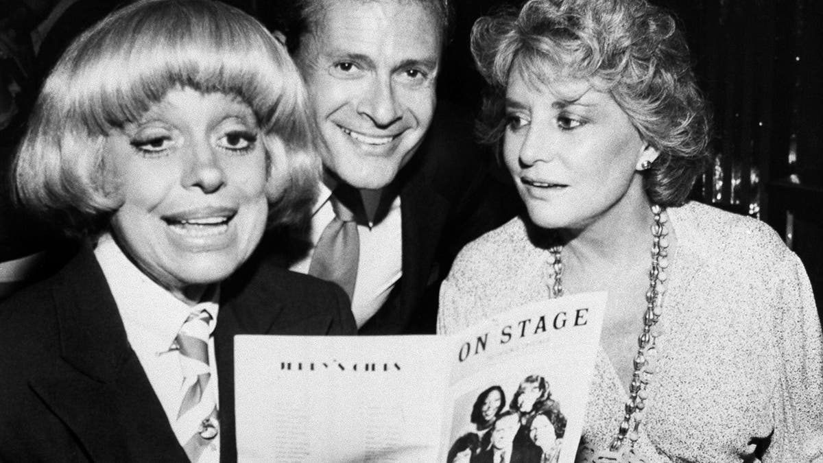 FILE - In this Sept. 1, 1981, file photo, Carole Channing, left, and television personality Barbara Walters look over the program with composer-lyricist Jerry Herman at a Broadway Theater.