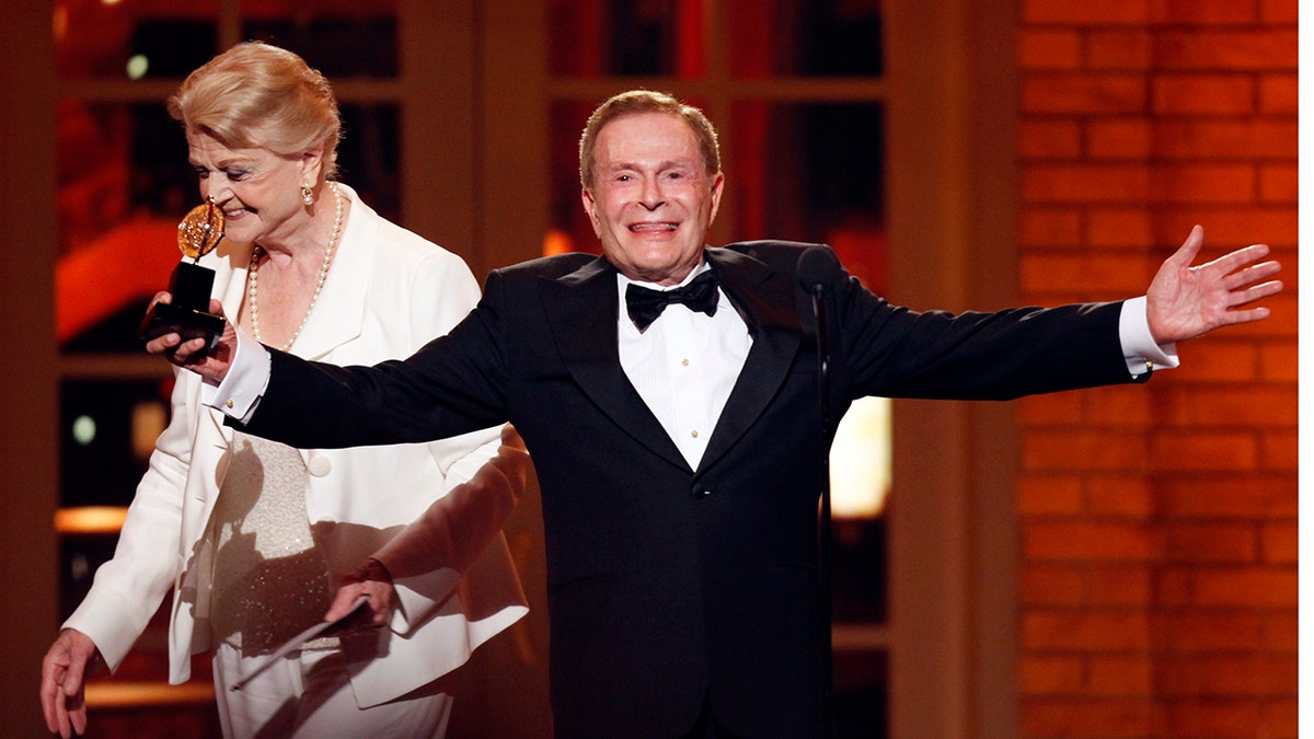 In this June 7, 2009, file photo, Jerry Herman accepts his Special Tony Award for Lifetime Achievement in the Theater from Angela Lansbury at the 63rd Annual Tony Awards in New York.