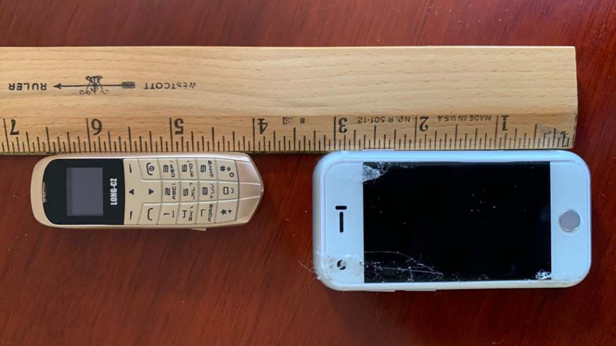 The tiny cellphones discovered hidden underneath the insoles of the shoes all measured about 3 inches long.