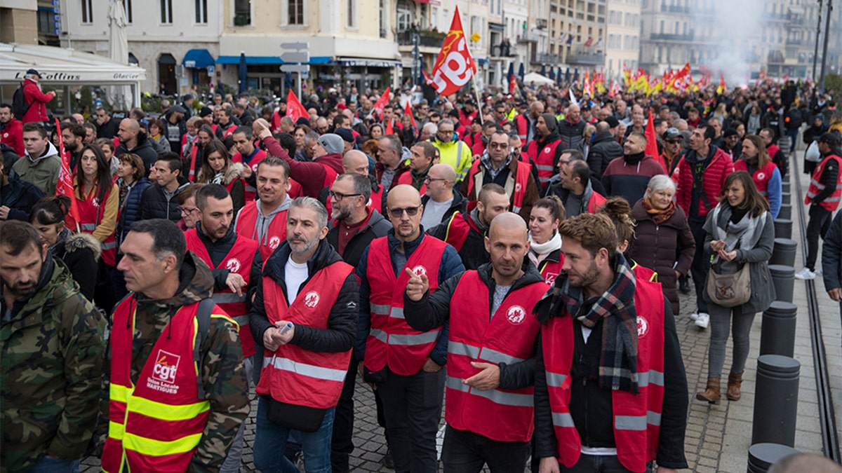 Protesters march during a mass strike in the Old Port of Marseille, southern France, on Thursday.