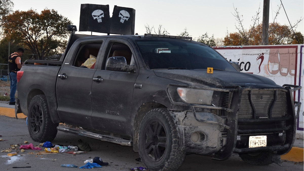 A damaged pick up is on a street of Villa Union, Mexico, after a gun battle between Mexican security forces and suspected cartel gunmen on Saturday.