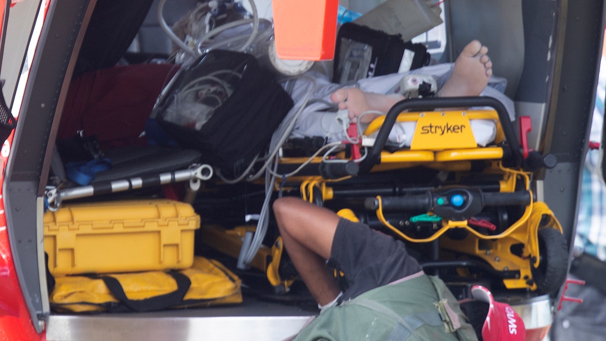 Emergency services attend to an injured person arriving at the Whakatane Airfield after the volcanic eruption Monday, Dec. 9, 2019, on White Island, New Zealand.