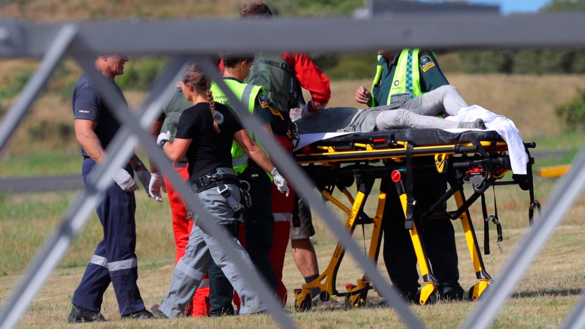Emergency services attend to an injured person arriving at the Whakatane Airfield after the volcanic eruption Monday, Dec. 9, 2019, on White Island, New Zealand.