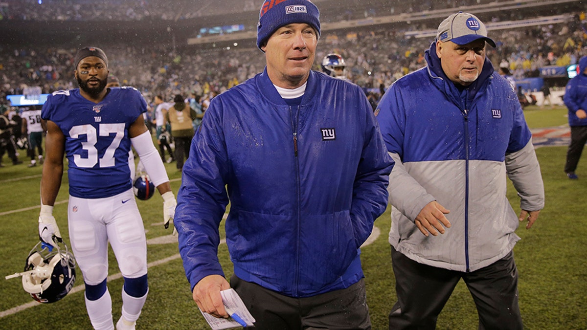 New York Giants head coach Pat Shurmur, center, leaves the field Sunday following the team's defeat to the Philadelphia Eagles. The Giants finished 4-12 on the season.