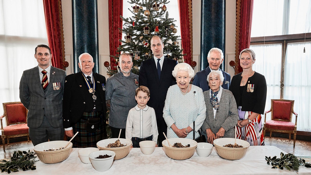 Queen Elizabeth, Prince Charles, Prince William and Prince George, alongside, from left, veterans Liam Young, Colin Hughes, Alex Cavaliere, Barbra Hurman and Lisa Evans,at the launch of The Royal British Legion's Together at Christmas initiative. (Chris Jackson/Buckingham Palace via AP)