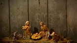 A new artwork dubbed "Scar of Bethlehem" by the artist Banksy is displayed in The Walled Off Hotel, in the West Bank city of Bethlehem, Sunday, Dec. 22, 2019. (AP Photo/Majdi Mohammed)
