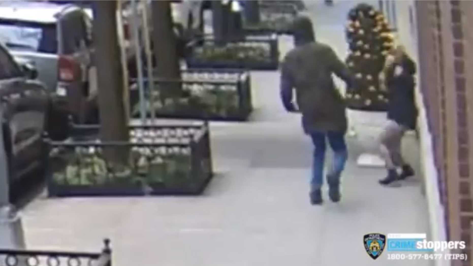 The suspect can be seen swinging at a 21-year-old woman who was on her phone. (NYPD CrimeStoppers)