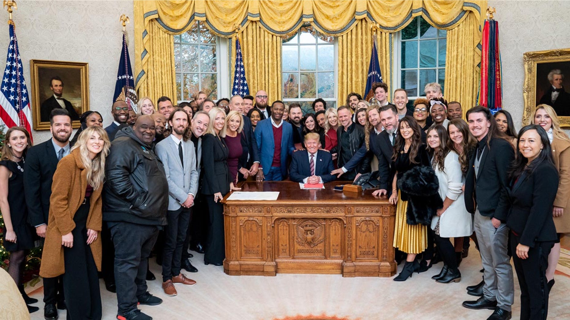 Feucht leaning across several people to touch Trump’s sleeve at a prayer that included about 50 worship leaders across America.