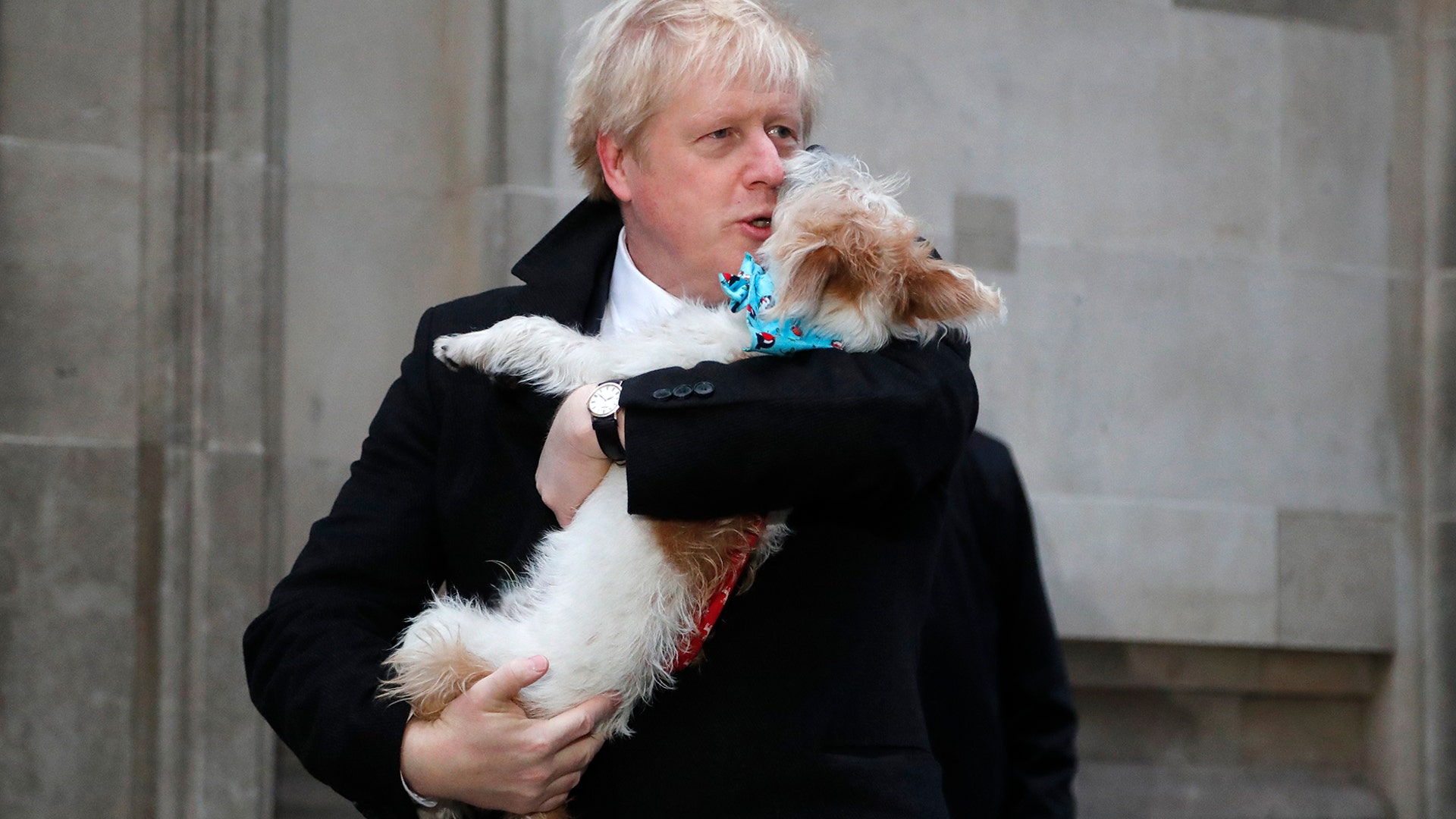 Britain's Prime Minister holds his dog Dilyn after voting in the general election at Methodist Central Hall, Westminster, London, Dec. 12, 2019. 