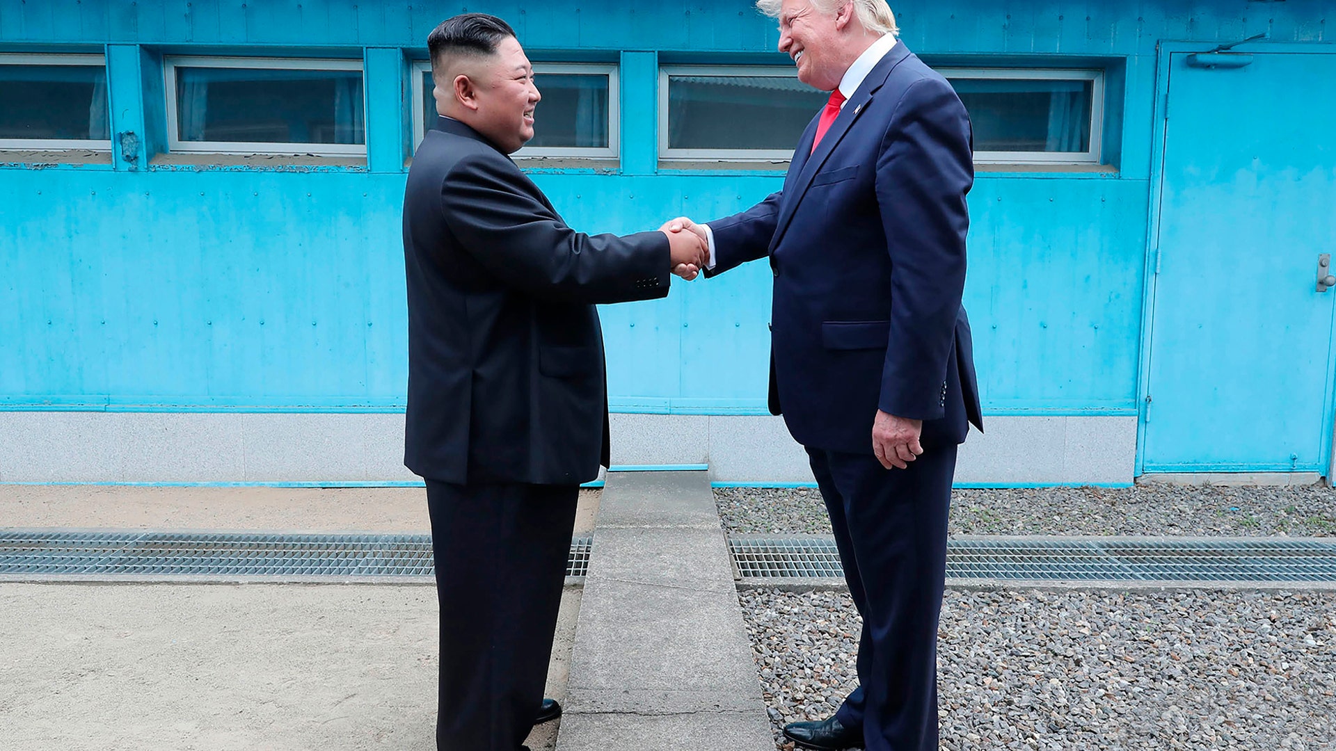 North Korean leader Kim Jong Un and President Donald Trump shake hands over the military demarcation line at the border village of Panmunjom in Demilitarized Zone, June 30, 2019.
