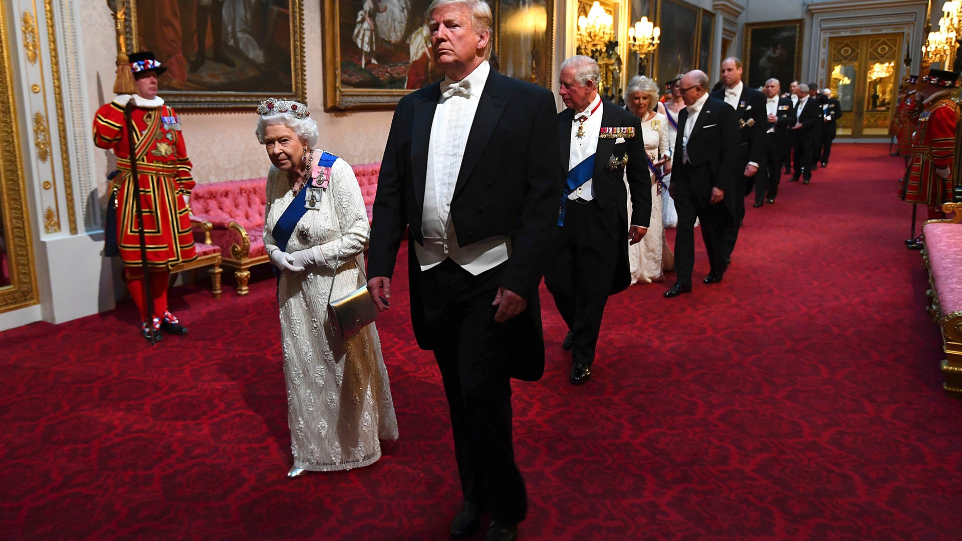 Queen Elizabeth II and President Donald Trump arrive through the East Gallery for a State Banquet at Buckingham Palace in London, June 3, 2019.