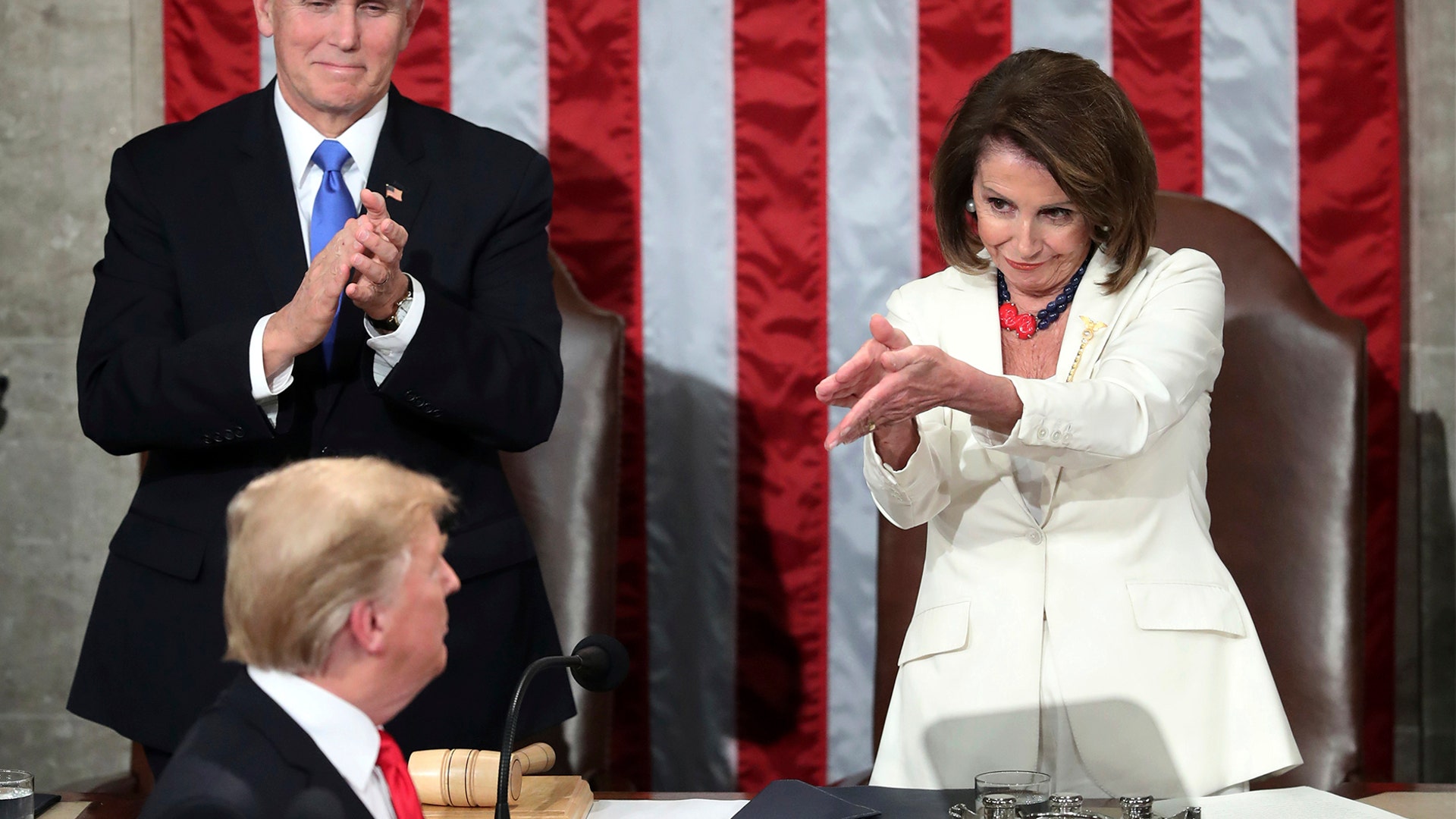 President Donald Trump turns to House Speaker Nancy Pelosi and Vice President Mike Pence as he delivers his State of the Union address to a joint session of Congress on Capitol Hill in Washington, Feb. 5, 2019. 