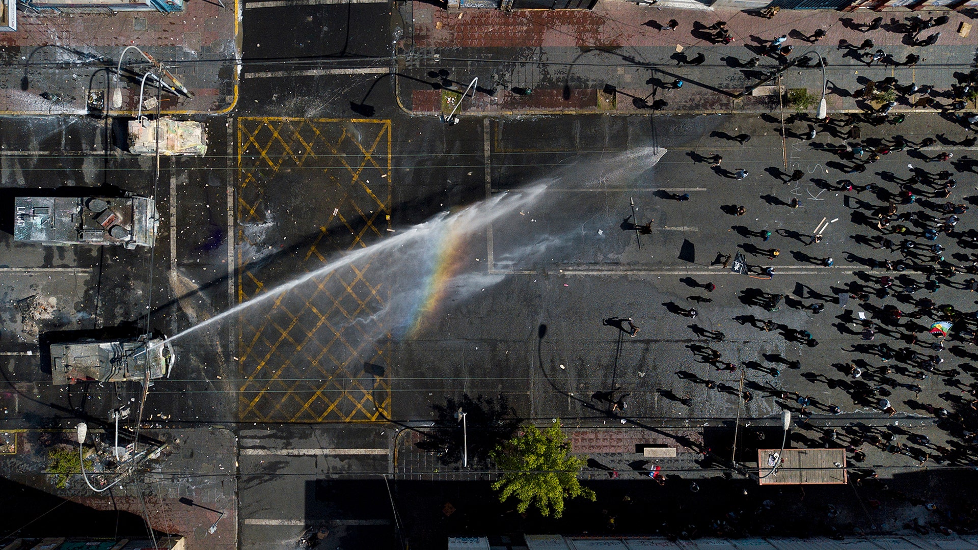 A police water cannon sprays anti-government demonstrators in Valparaiso, Chile, Oct. 26, 2019. 