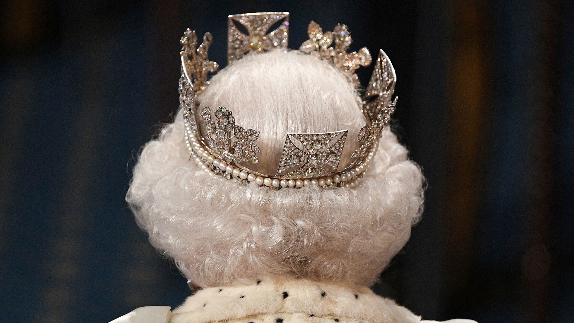 Britain's Queen Elizabeth II proceeds through the Royal Gallery before delivering the Queen's Speech during the State Opening of Parliament in London, Oct. 14, 2019. 