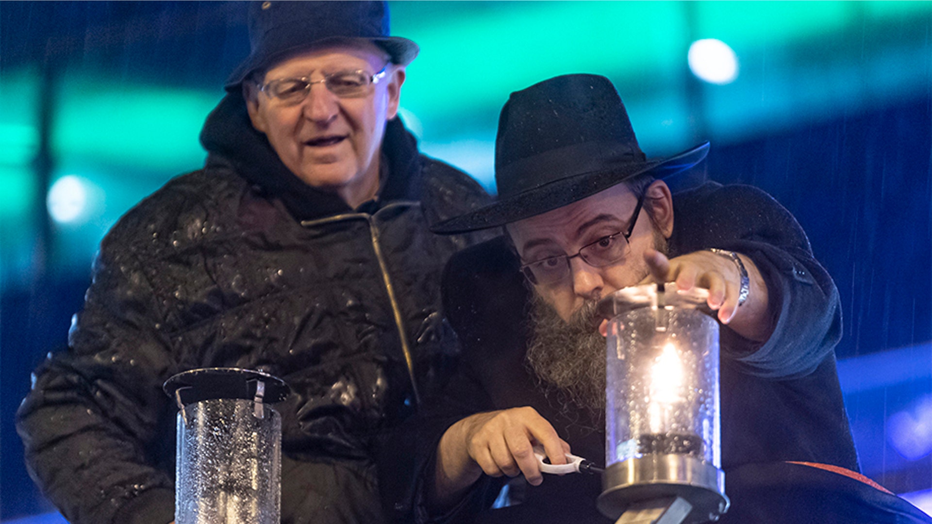 Budapest, Hungary: Hungarian Hasidic Jewish religious leader Baruch Oberlander, right, lights the first lantern on a menorah as mayor of the 13th district Jozsef Toth looks on in a square in central Budapest, Hungary.