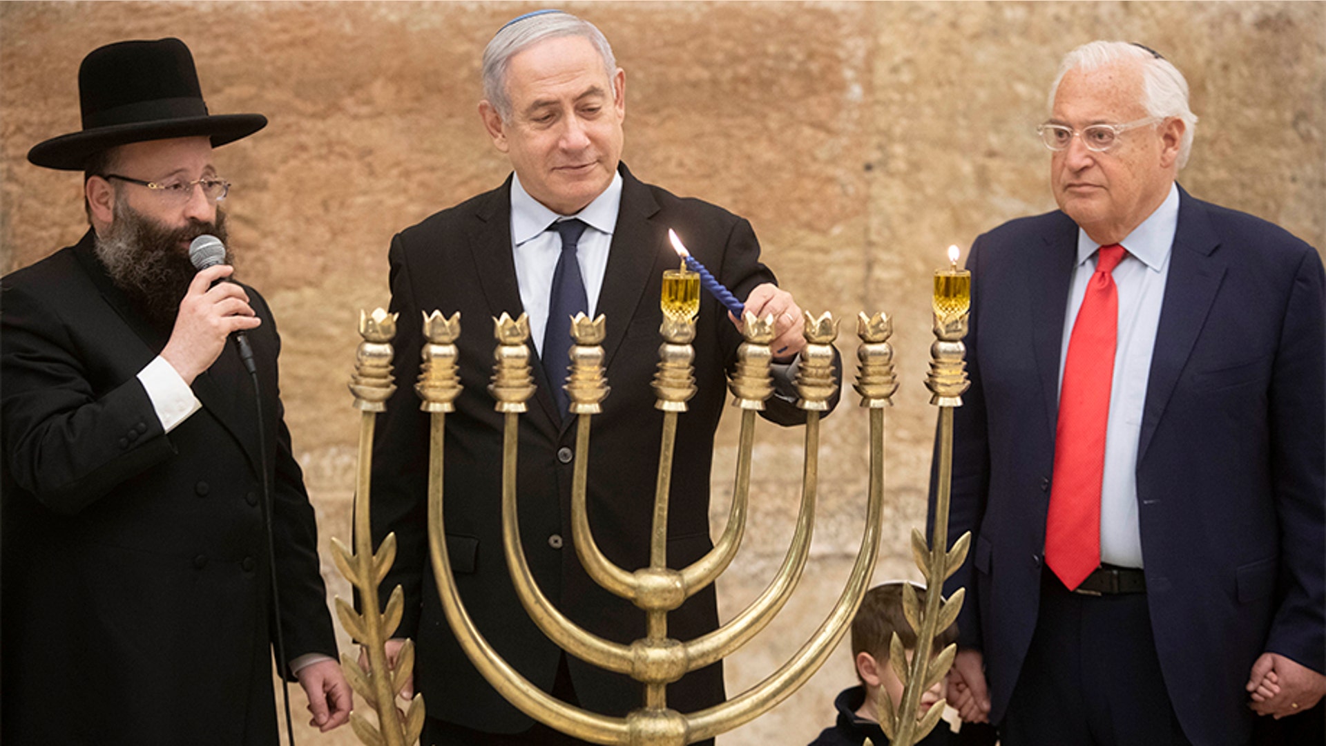 Jerusalem, Israel: Prime Minister Benjamin Netanyahu lights Hanukkah candles with US Ambassador to Israel David Friedman, at the Western Wall, the holiest site where Jews can pray in Jerusalem's old city,