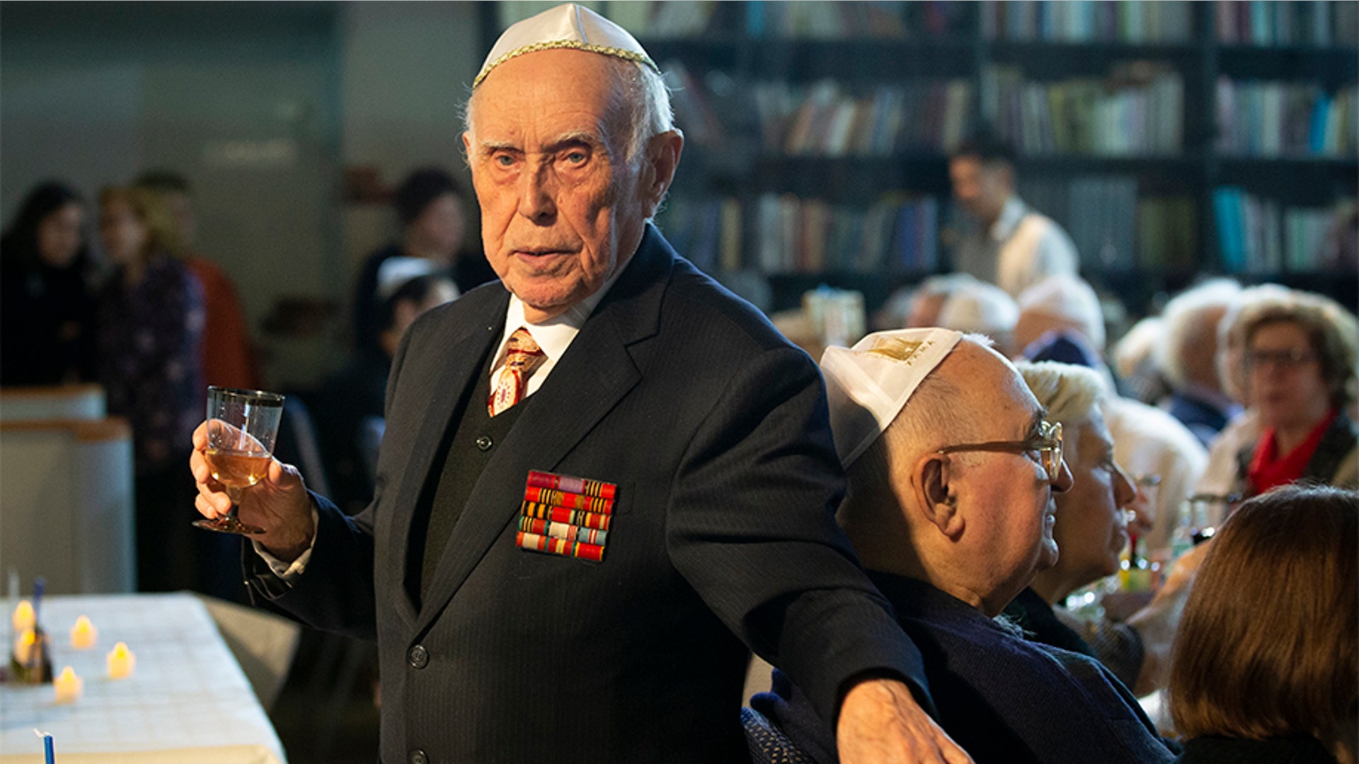 Moscow, Russia: Holocaust survivor and WWII veteran Mikhail Spectr, 86, walks to make a toast. Spectr was taken to Jewry in 1941 at the age of 8 when Nazi soldiers arrived at his village in Ukraine Soviet republic. Spectr had been kept at ghetto in Transnistria, territory between Dniester and Southern Bug, occupied by the Nazi and its allies from 1941 and 1944.