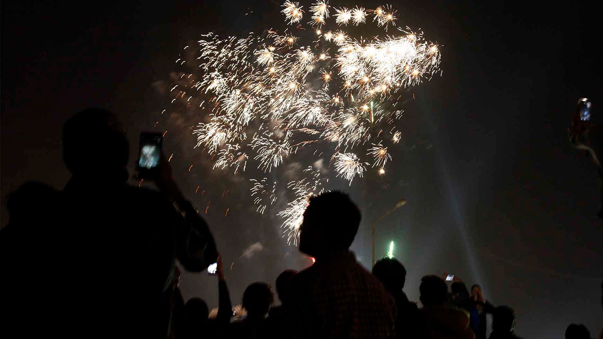 Karachi, Pakistan: People celebrate the new year in downtown. (AP Photo/Ikram Suri)