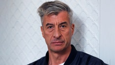 Artist behind anti-Trump gold toilet tapes banana to wall in expensive, wacky work