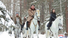 Kim Jong Un pictured riding white horse toward sacred mountain