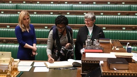 2 UK lawmakers sworn into Parliament while carrying their babies