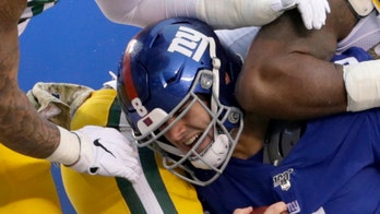 New York Giants' Daniel Jones receives hard hit, part of helmet decal flies off