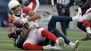 Arizona Cardinals' Larry Fitzgerald pokes fun at dad after his phone rings during media scrum