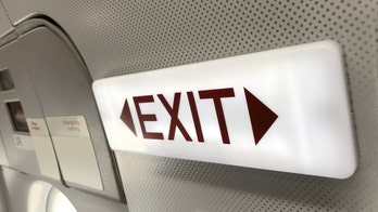 British Airways passenger attempts to open emergency door during panic attack, is calmed by boxer's entourage