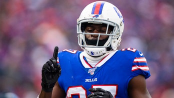 Buffalo Bills' Tre'Davious White sneaks a peak at Baltimore Ravens' play sheets blown onto field