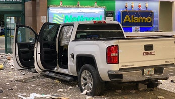 Pickup truck crashes through Florida airport's baggage claim area, slams into rental car counter