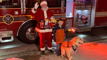 Boy denied visit with Santa because of his service dog gets surprise from fire department