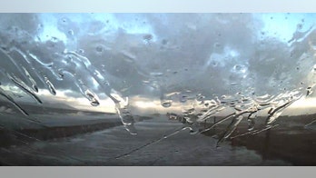 Car slammed by waves escapes flood in dramatic dashcam video