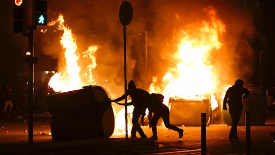 At highly anticipated Barcelona-Real Madrid soccer match, riot police and protesters clash outside