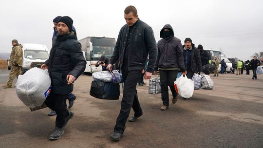 Ukraine, pro-Russian separatists swap prisoners in step to end 5-year war