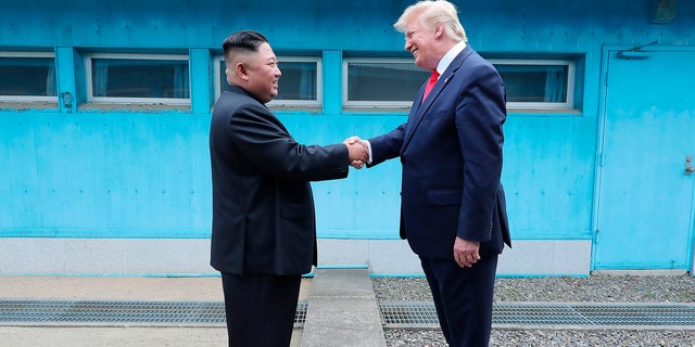 In this Sunday, June 30, 2019, photo provided by the North Korean government, North Korean leader Kim Jong Un, left, and U.S. President Donald Trump shake hands over the military demarcation line at the border village of Panmunjom in Demilitarized Zone. (Korean Central News Agency/Korea News Service via AP)