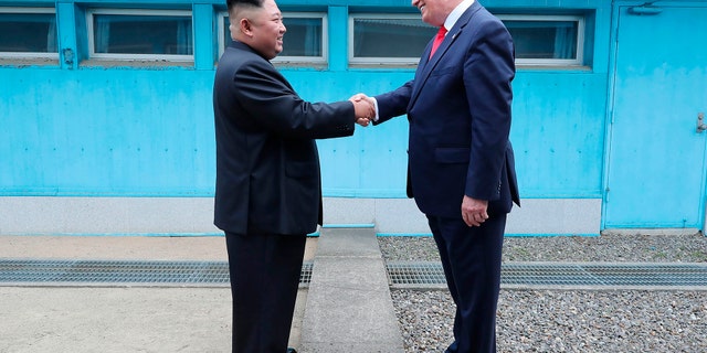 In this Sunday, June 30, 2019, photo provided by the North Korean government, North Korean leader Kim Jong Un, left, and U.S. President Donald Trump shake hands over the military demarcation line at the border village of Panmunjom in Demilitarized Zone. (Associated Press)