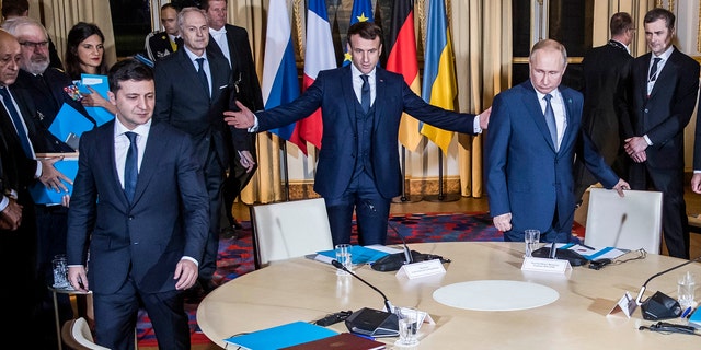 Russian President Vladimir Putin, right, French President Emmanuel Macron, center, and Ukrainian President Volodymyr Zelenskiy arrive at a working session at the Elysee Palace Monday, Dec. 9, 2019 in Paris. Russian President Vladimir Putin and Ukraine's president are meeting for the first time at a summit in Paris to find a way to end the five years of fighting in eastern Ukraine.