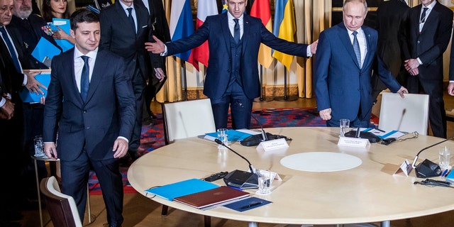 Russian President Vladimir Putin, right, French President Emmanuel Macron, center, and Ukrainian President Volodymyr Zelenskiy arrive at a working session at the Elysee Palace Monday, Dec. 9, 2019 in Paris. Russian President Vladimir Putin and Ukraine's president are meeting for the first time at a summit in Paris to find a way to end the five years of fighting in eastern Ukraine.