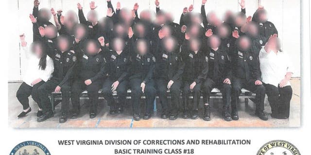 Multiple people have been either fired or suspended in connection with a photo that appeared to show corrections trainees giving a Nazi salute.