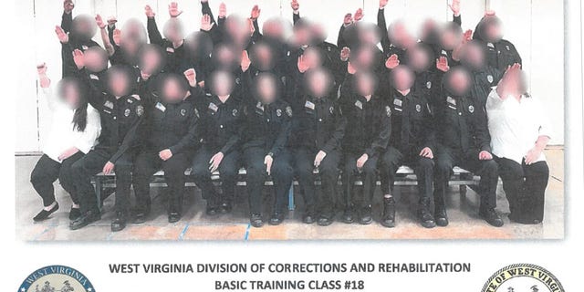 Multiple people have been either fired or suspended in connection with a photo that appeared to show corrections trainees giving a Nazi salute.