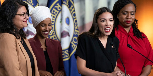 U.S. Rep. Alexandria Ocasio-Cortez, D-N.Y., speaks as, from left, Rep. Rashida Tlaib, D-Mich., Rep. Ilhan Omar, D-Minn., and Rep. Ayanna Pressley, D-Mass., listen during a news conference at the Capitol in Washington, Monday, July 15, 2019. (AP Photo/J. Scott Applewhite)